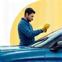 Technician detailing a car